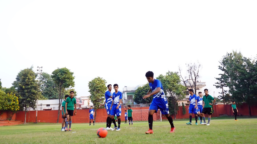The Asian School Student playing Football